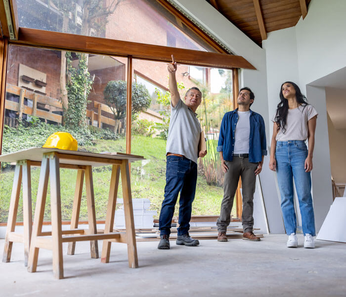 Building contractor talking to clients renovating their house