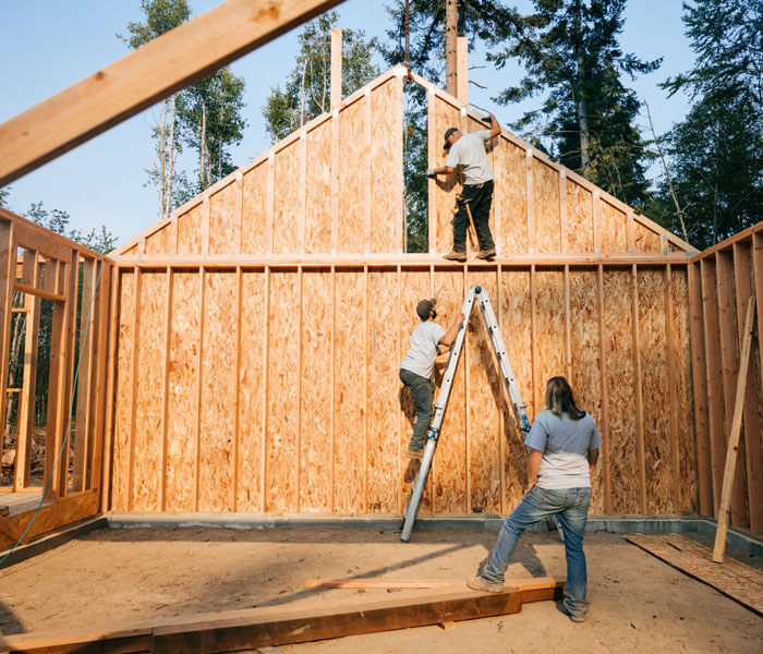 Workers building the frame of a new house project