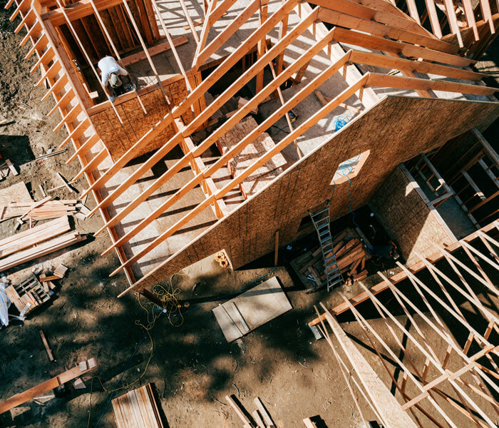Workers build the frame of a new house project